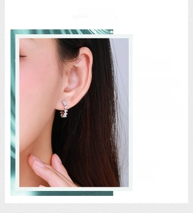 Close-up of S925 sterling silver C-shaped earrings featuring baguette-cut zircon stones