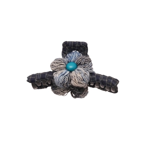 Minimalist knit flower hair claw with grey-blue petals and navy checkered fabric cover
