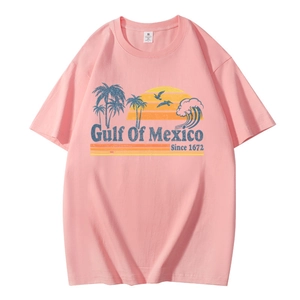 Detailed view of pink t-shirt featuring retro Gulf Of Mexico palm tree and sunset print