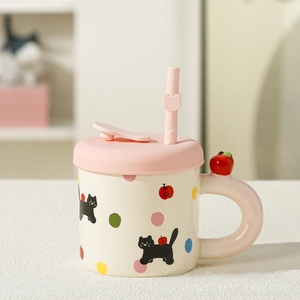 Detail of cute ceramic cat mug with pink lid, straw and unique 3D red apple handle decoration
