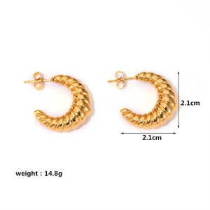 Macro shot of gold croissant earrings showing 2.1cm diameter and 14.8g weight specs