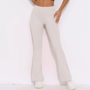 Detail view of cream high-waisted flared yoga leggings with elastic sports fabric