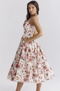 Detail view of floral midi dress featuring side pockets and elegant spaghetti straps