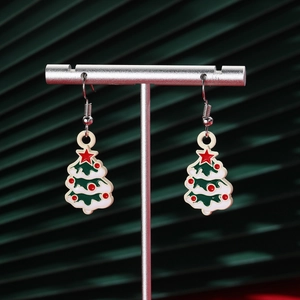 Detail view of festive Christmas tree drop earrings with stars on silver T-stands