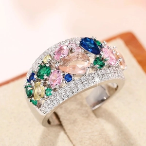 Macro shot of silver ring with colorful teardrop gemstones and micro-pave crystals