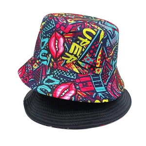 Detail of reversible bucket hat showing graffiti lip print and plain black lining