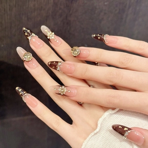 Long almond press-on nails with pink base, chocolate French tips and luxury rhinestones