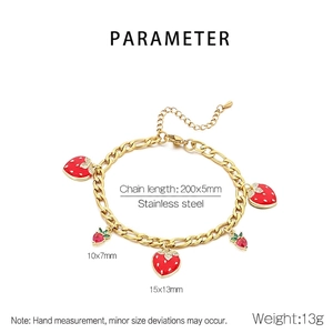 Detail of strawberry charm bracelet in gold finish with stainless steel chain links