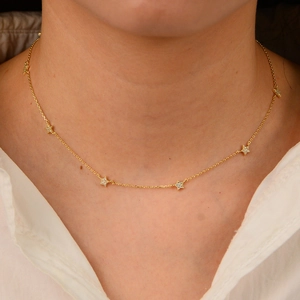 Elegant gold S925 sterling silver star pendant necklace worn on neck as choker
