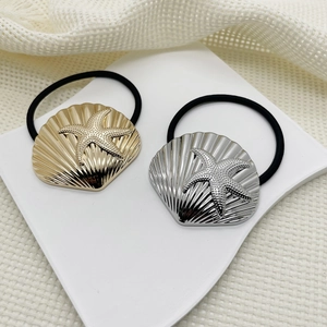 Two-piece set of gold and silver shell and starfish metal hair ties on display stands