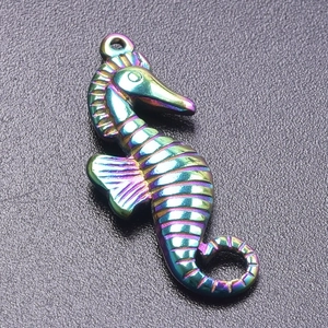 Macro shot of iridescent rainbow seahorse pendant with textured metallic finish