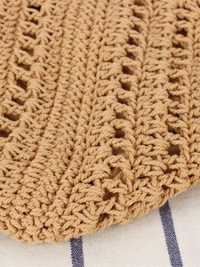 Khaki hand-woven triangular shoulder bag featuring intricate hollow knit pattern and texture