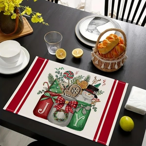 Christmas linen placemat with Snowman and JOY design on a dark wood dinner table