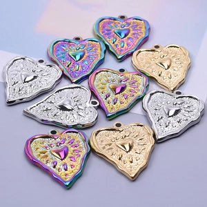 Close-up of heart-shaped 304 stainless steel pendants in gold, silver, and rainbow finishes