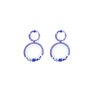 Detail of blue and white porcelain style acrylic double hoop earrings with floral patterns