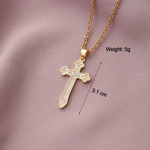 Detailed macro view of a gold cross pendant with cubic zirconia on purple fabric