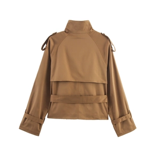 Detail view of khaki short trench coat featuring back storm flap and sleeve strap details
