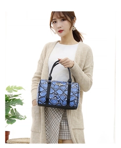 Blue snakeskin Boston bag detail with black patent leather handles and gold metal accents