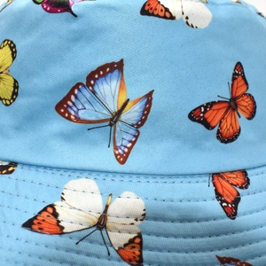 Close-up of sky blue bucket hat with colorful butterfly prints and durable stitched brim