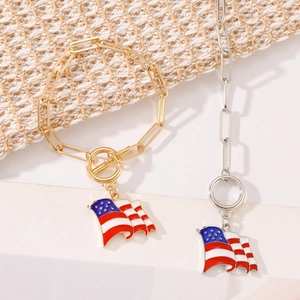 Detail of USA Independence Day flag charms on gold and silver paperclip link bracelets