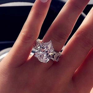 Luxury silver ring featuring a large pear-cut zircon and full diamond pavé band