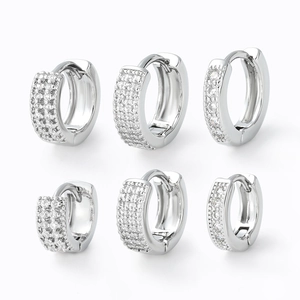 Three pairs of silver huggie hoop earrings with micro-paved cubic zirconia in various widths