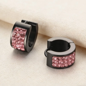 Macro detail of black plated stainless steel earrings with three rows of pink rhinestones