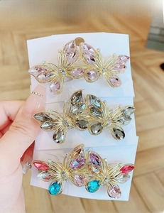 Detailed view of handmade crystal butterfly hair clips in pink and dark gray set