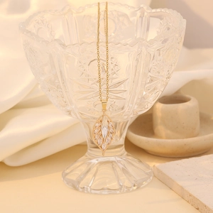 Elegant gold-plated leaf pendant necklace with shimmering marquise-cut crystal stones