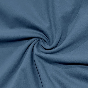 Macro detail of navy blue twill fabric showing soft knit texture and woven pattern