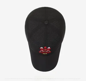Top view of black baseball cap featuring lion head embroidery and breathable mesh holes