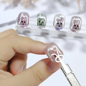 Cat eye nail art kit featuring pearly animal charms and metallic rabbit shaped magnet tools