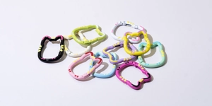 Macro shot of colorful cat-shaped metal spring ring buckles in assorted macaron colors