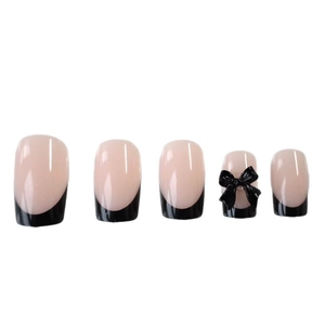 Pink and black French press-on nails with 3D bow design in a minimalist almond shape