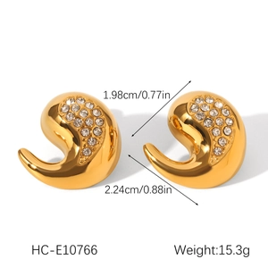 Vue détaillée de boucles d'oreilles larmes dorées avec zircon montrant taille et poids
