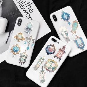 Detail of Chinese style stickers with lanterns and mirrors on white smartphone cases