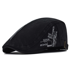 Close-up of black cotton flat cap with fashion embroidery and metal adjustable buckle