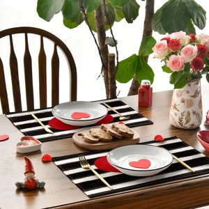 Close-up of heart pattern linen placemats with black stripes for Valentine table setting
