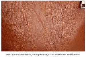 Close-up of caramel brown pebble grain leather texture with a metal zipper detail
