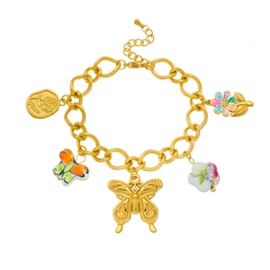 Detail of gold chain bracelet with ceramic flower, butterfly charms and Rose engraving