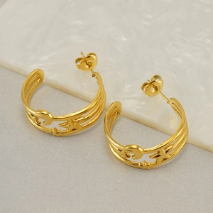 Gold stainless steel C-shaped hoop earrings featuring hollow star and moon cutout designs