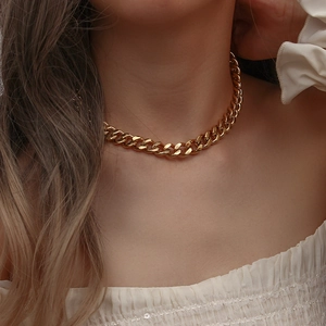 Close-up of 11mm wide gold Cuban chain necklace shown on a model's neck for scale