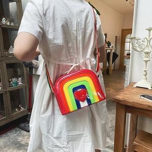 Close-up of rainbow heart crossbody bag in glossy finish with adjustable strap