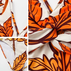 Detail of orange maple leaf print and knot design on one-shoulder swimsuit set