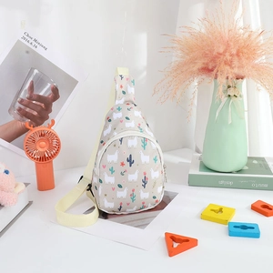 Detail of kids beige nylon crossbody bag featuring cute cartoon alpaca and flower prints