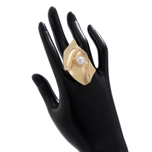 Detail of gold spiral ring featuring a white faux pearl on a sleek black display model
