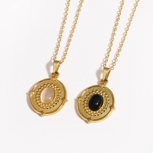 Detailed shot of 14K gold-plated O-chains with natural white opal and black onyx pendants
