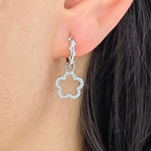 Detailed close-up of a silver flower hoop earring featuring cubic zirconia pave setting