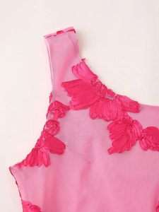 Close-up of rose pink sleeveless dress with embroidered silk flower patches on mesh