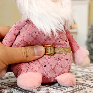 Detail of pink sequin Christmas doll showing plush fabric and long white faux fur beard